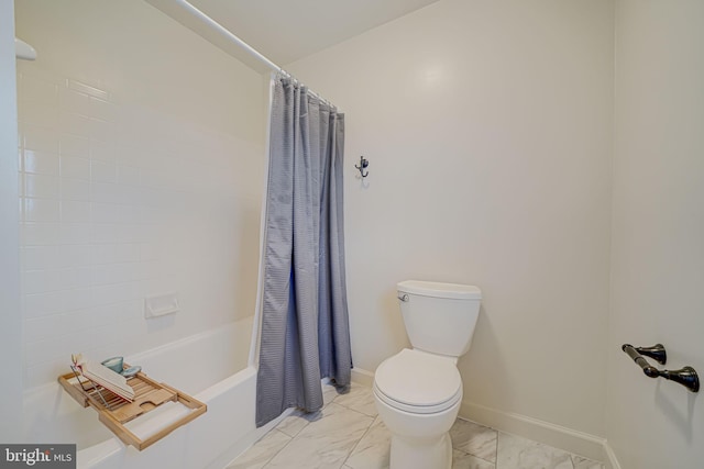 full bath featuring toilet, baseboards, marble finish floor, and shower / tub combo with curtain