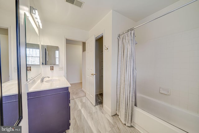 full bathroom with visible vents, shower / bath combination with curtain, vanity, and baseboards