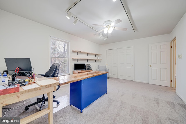 office featuring baseboards, light carpet, ceiling fan, and track lighting