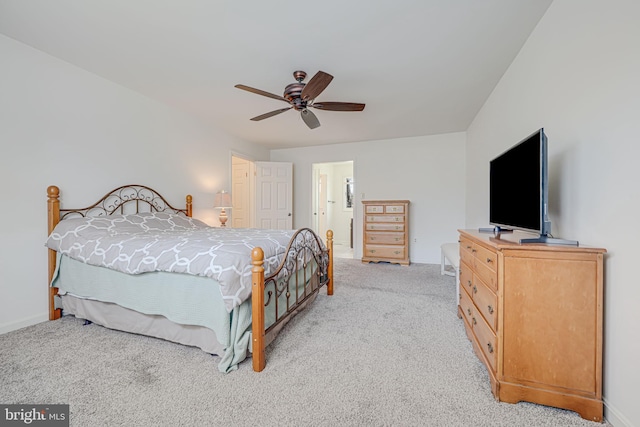 bedroom featuring light carpet, a ceiling fan, and baseboards