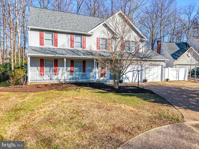 view of front facade featuring a porch, a front lawn, driveway, and a shingled roof