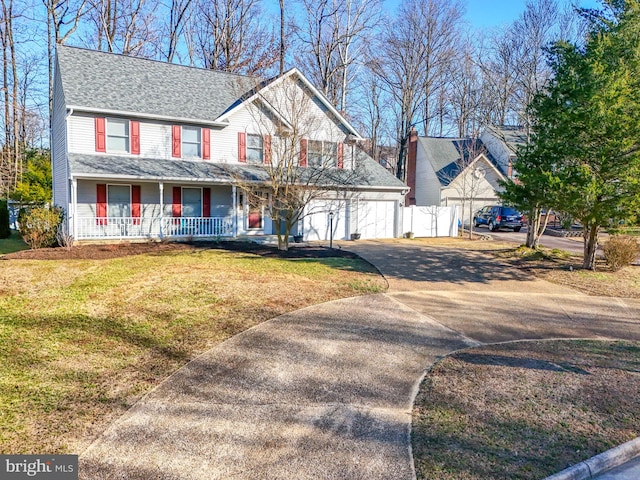 view of front of home with a front lawn, driveway, fence, covered porch, and a shingled roof