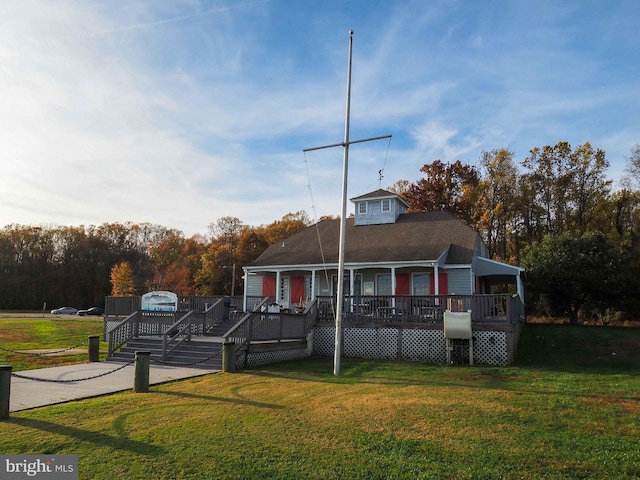 view of front of house featuring a deck and a front lawn