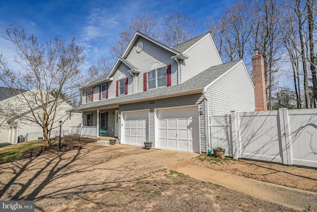 traditional-style home with driveway, a gate, fence, roof with shingles, and covered porch