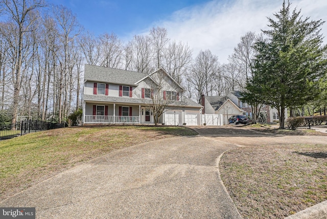 view of front of property with a front lawn, fence, a porch, a garage, and driveway