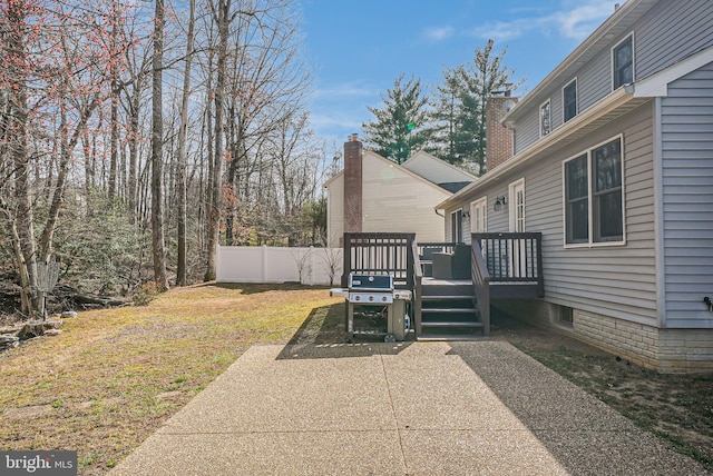 view of yard featuring a wooden deck and fence