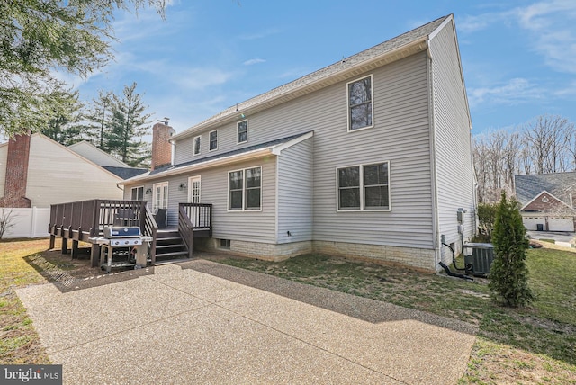 back of house with fence, central AC unit, a wooden deck, a chimney, and a patio area