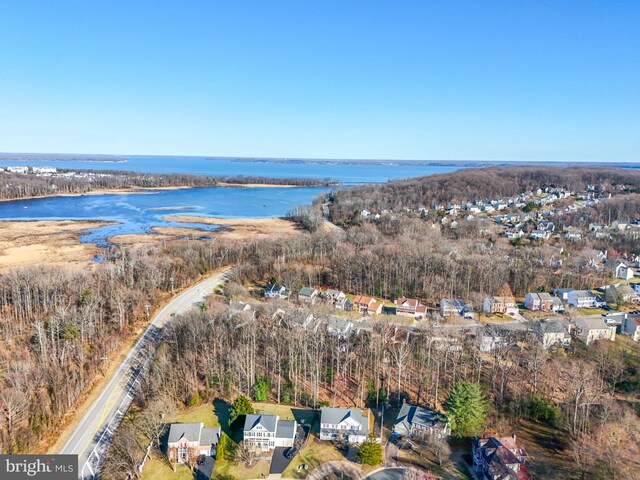 drone / aerial view with a residential view and a water view