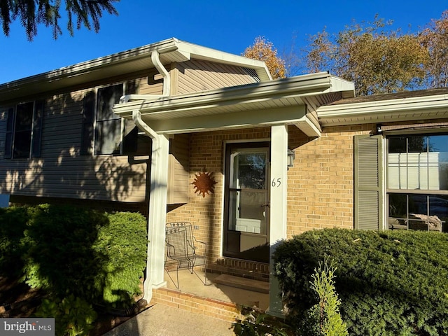 entrance to property featuring brick siding