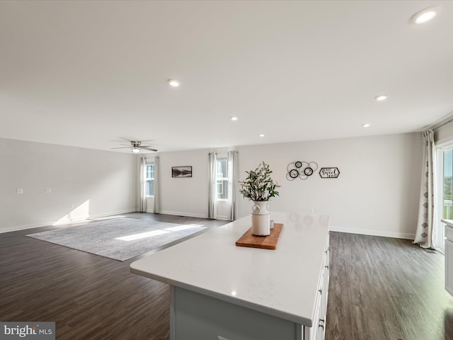 kitchen with baseboards, a ceiling fan, and dark wood-style floors