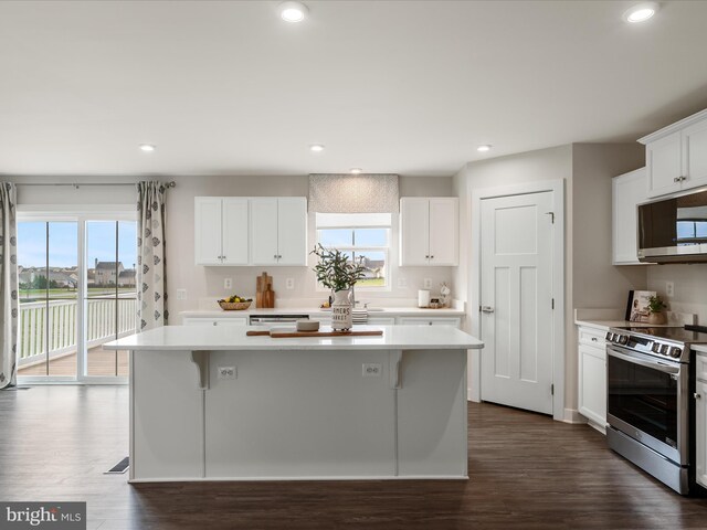kitchen with plenty of natural light, a center island, light countertops, and appliances with stainless steel finishes
