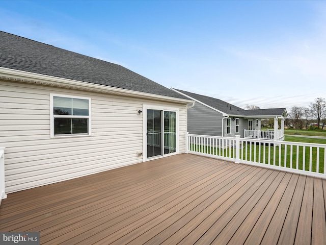 wooden deck featuring a yard
