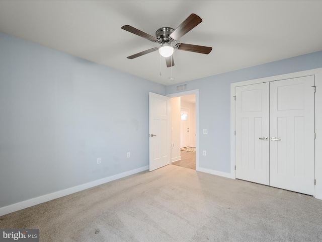unfurnished bedroom with visible vents, baseboards, a closet, ceiling fan, and carpet