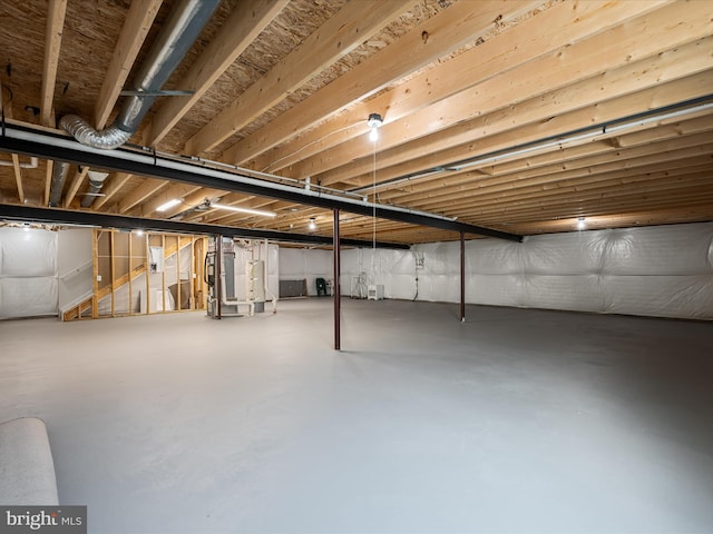 unfinished below grade area featuring water heater