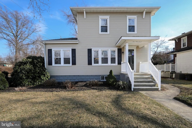 view of front facade featuring a front yard and cooling unit