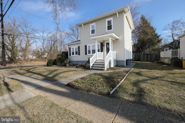 view of front of property with a front yard and fence