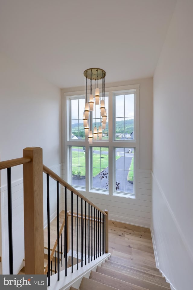 11 Sailfish Dr, Mechanicsburg, PA 17050 - staircase with a chandelier, wood finished floors, and wainscoting