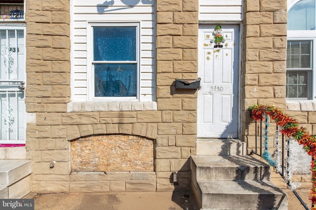 view of exterior entry featuring stone siding