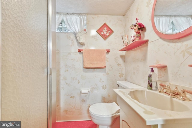 bathroom with toilet, an enclosed shower, vanity, and wallpapered walls