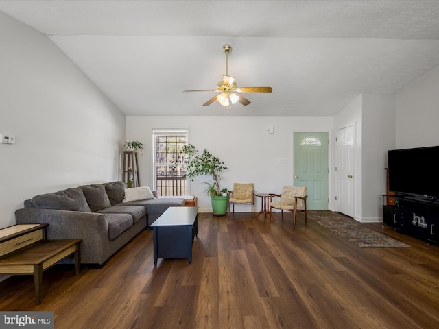 living room featuring ceiling fan, baseboards, vaulted ceiling, and wood finished floors