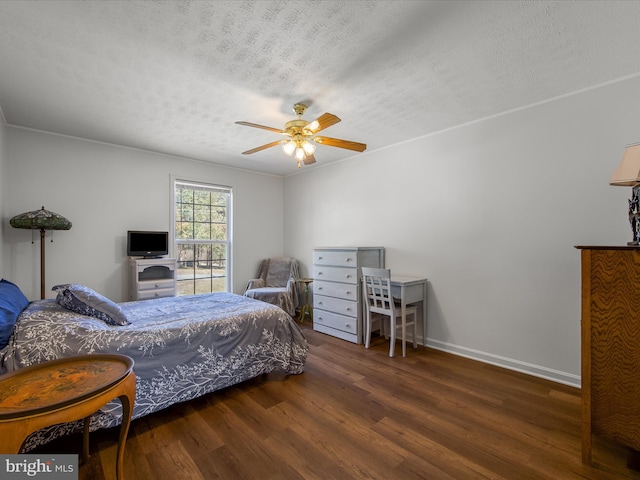 bedroom featuring a ceiling fan, a textured ceiling, baseboards, and wood finished floors