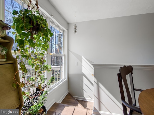 interior space with wood finished floors and baseboards