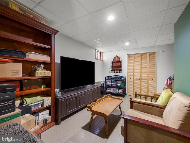 living room with a paneled ceiling and recessed lighting