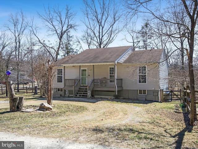 view of front facade featuring fence and a wooden deck