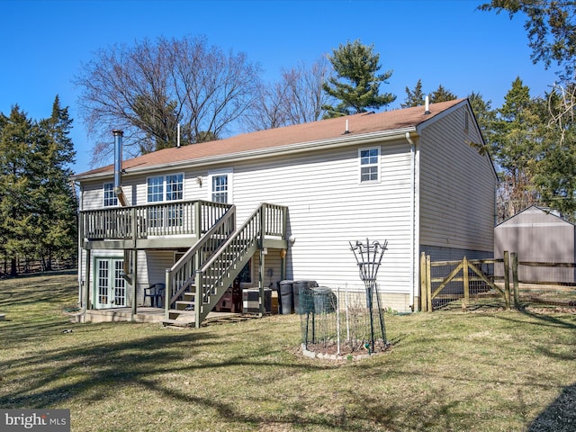 rear view of house featuring a yard, a gate, fence, a deck, and stairs