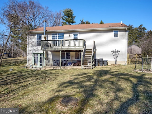 back of property featuring stairs, a deck, a lawn, and french doors