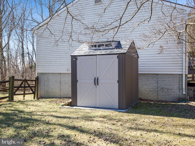 view of shed featuring fence