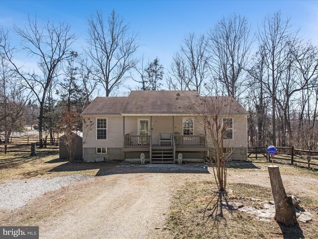 view of front of property featuring fence and a wooden deck