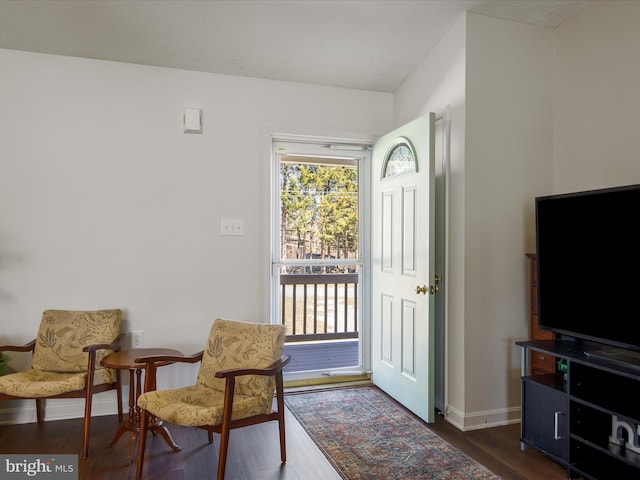 living area featuring dark wood-style floors and baseboards