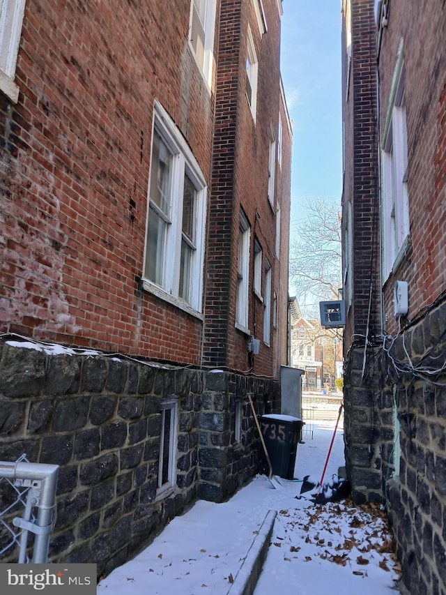 view of side of property featuring brick siding