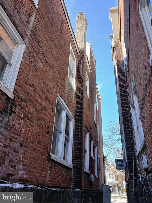 view of side of property featuring brick siding