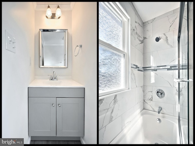 bathroom with washtub / shower combination, ornamental molding, and vanity