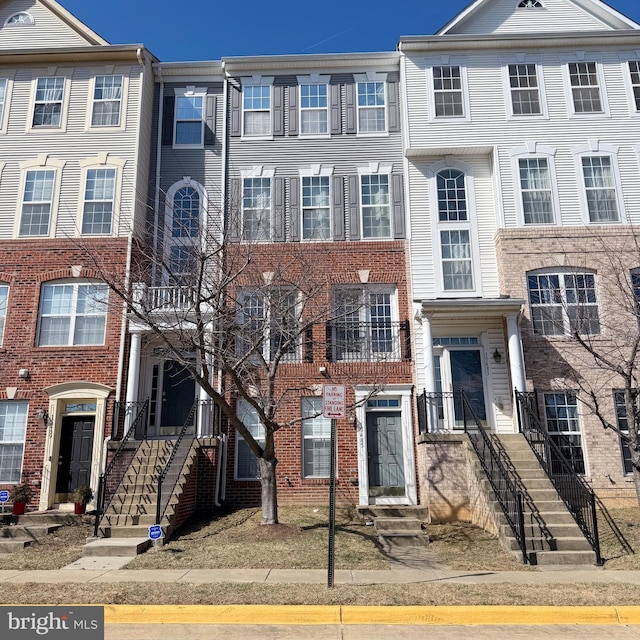 townhome / multi-family property with brick siding