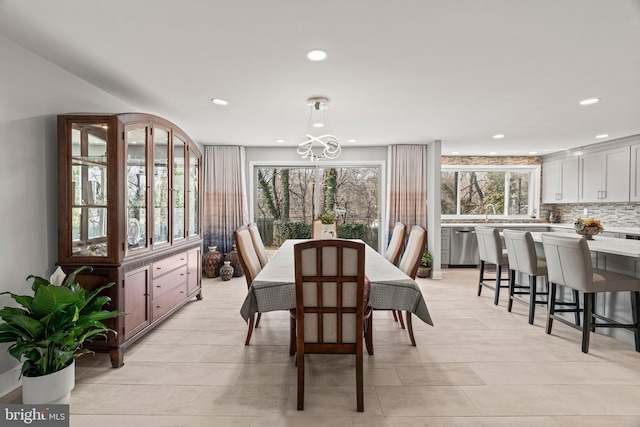 dining area featuring recessed lighting and an inviting chandelier