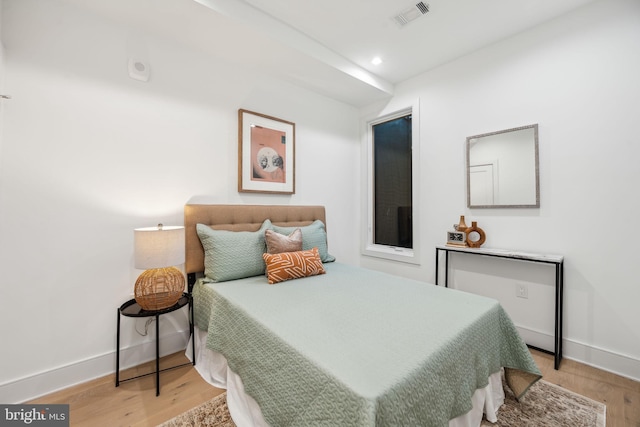 bedroom with recessed lighting, visible vents, baseboards, and wood finished floors