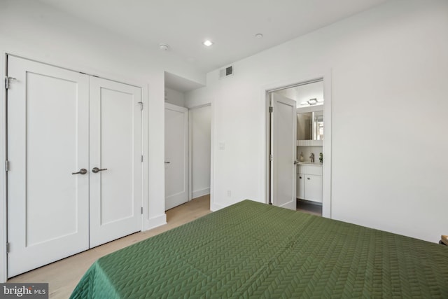 unfurnished bedroom with recessed lighting, visible vents, a closet, and ensuite bathroom