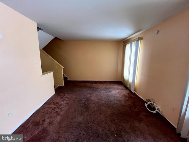 unfurnished living room with stairway and carpet