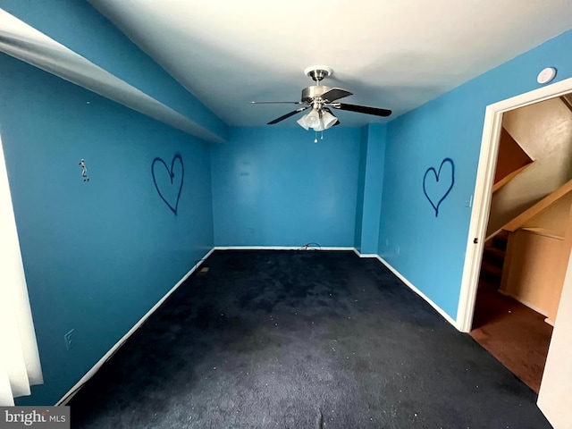 empty room featuring baseboards and a ceiling fan