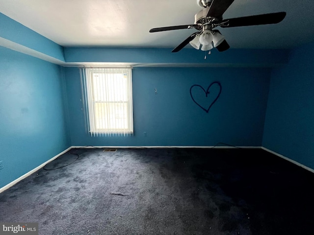 empty room with carpet floors, baseboards, and visible vents