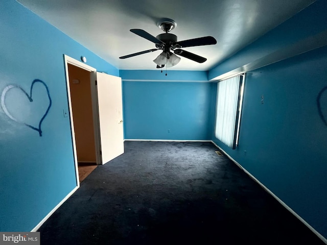 unfurnished room with carpet floors, baseboards, and a ceiling fan