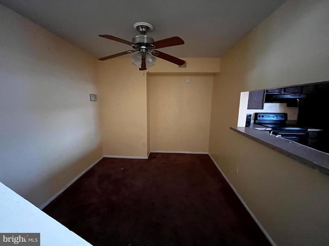 interior space with a ceiling fan, carpet flooring, and baseboards