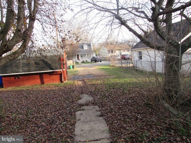 view of yard featuring a residential view and fence