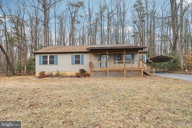 view of front of house featuring a carport, driveway, a porch, and a front lawn