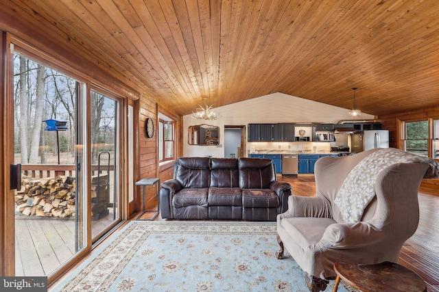 living area with lofted ceiling, wooden ceiling, a notable chandelier, wood walls, and wood finished floors