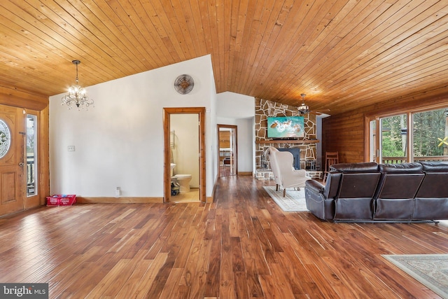 unfurnished living room featuring lofted ceiling, wooden ceiling, a fireplace, and hardwood / wood-style floors