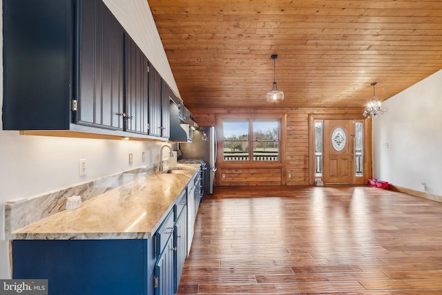 kitchen featuring wooden ceiling, blue cabinetry, wood finished floors, and lofted ceiling